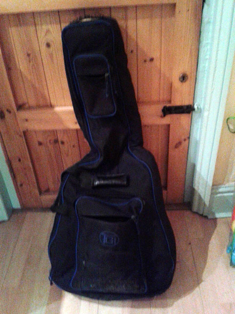 My guitar bag leaning against the door, just before we said goodbye for the last time